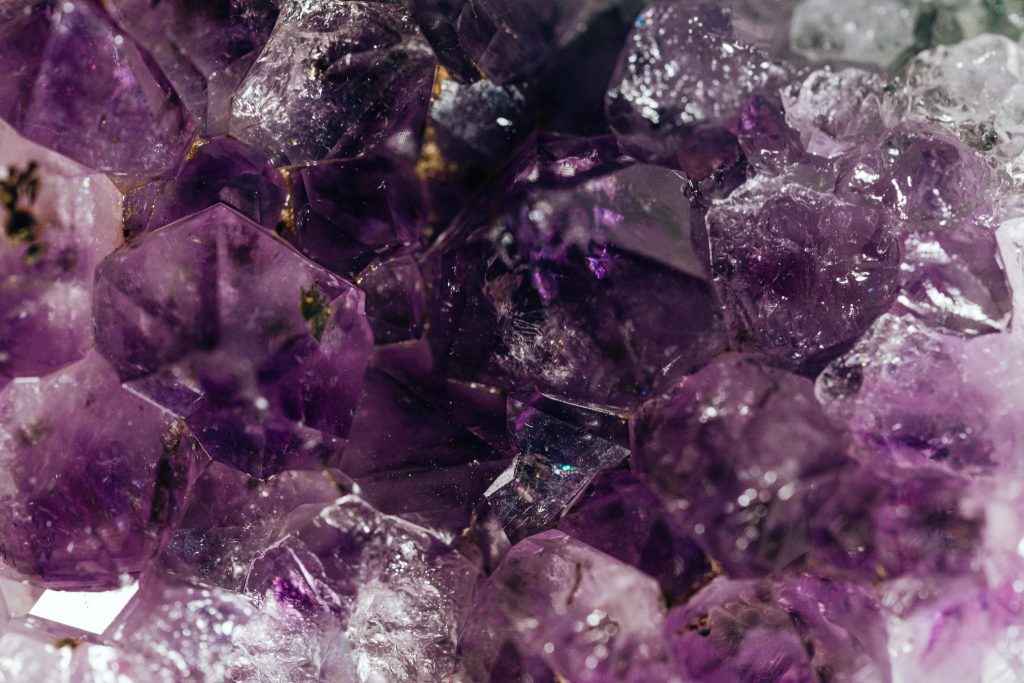 Detailed macro shot of natural amethyst crystals highlighting textures and purple hues.